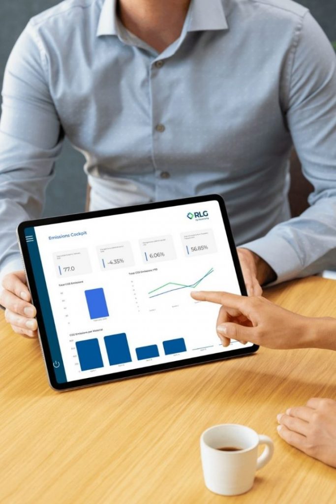 Man holding a tablet that shows a dashboard about data. Female hand points at the tablet.